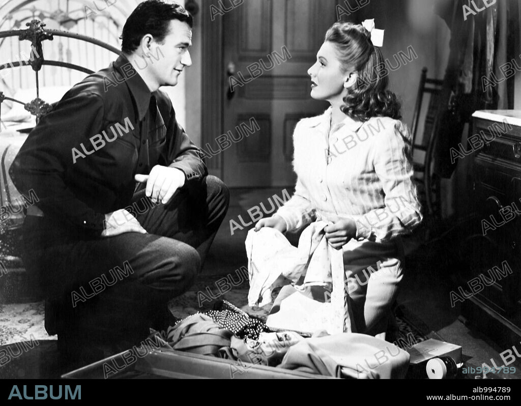 JEAN ARTHUR and JOHN WAYNE in A LADY TAKES A CHANCE, 1943, directed by WILLIAM A. SEITER. Copyright RKO.