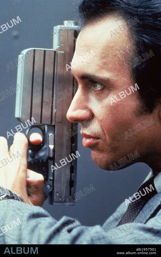 GENE SIMMONS in RUNAWAY, 1984, directed by MICHAEL CRICHTON. Copyright TRI STAR PICTURES.