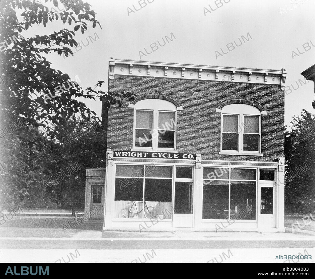 After a brief stint in the printing business, Orville and Wilbur Wright decided to open a bicycle shop together. After initially only selling and repairing bicycles in Dayton, Ohio, the Wright brothers began to make modifications on bicycles and to build their own models. They also took custom orders from their patrons. Still used today, their revolutionary oil-retaining wheel hub and coaster brakes made early bicycling easier and more comfortable. This photograph shows the Wright Cycle shop as it looked in 1937 after being moved to the Henry Ford Museum at Greenfield Village in Dearborn, Michigan. Behind the original shop, located at 1126 W. Third Street in Dayton, the Wrights assembled a frame addition where they built their first airplane.