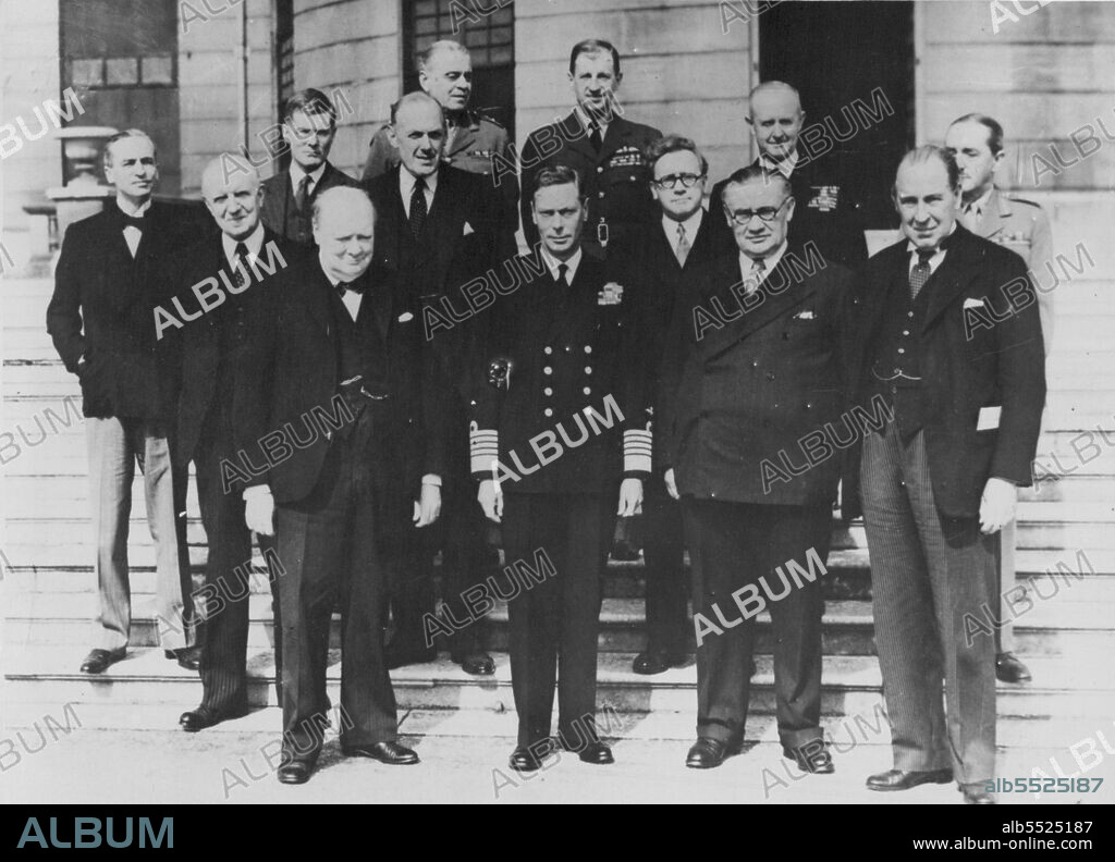 The Great Day Scenes At Buckingham Palace -- Photograph shows the King with members of his Cabinet showing :- Sir Archibald Sinclair, Lord Woolton, Mr. Winston Church, H.M. The King, Sir Charles Portal, Mr. Herbert Morrison, Mr. Ernest Bevin, Admiral Cunningham, Sir John Anderson and Sir Alan Brooke, outside the Palace. December 17, 1945. (Photo by L.N.A).