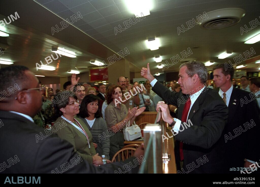 President George W Bush offers a 'thumbs up' to employees in the cafeteria of the Pentagon in Arlington, Virginia, September 17, 2001.
