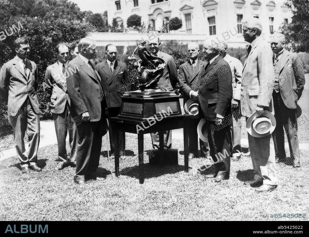 President Hoover presents the Collier Trophy, USA, April 10, 1929. President Herbert Hoover presents the The Robert J. Collier Trophy, an annual aviation award, to Joseph Ames, chairman of the National Advisory Committee for Aeronautics. Three years later, as part of his plan to increase efficiency in government, Hoover would sign an executive order to abolish the NACA. However, the election of Franklin D. Roosevelt prevented the implementation of President Hoover's executive and left the NACA intact.