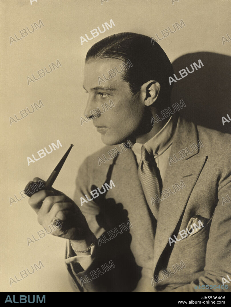 Rudolph Valentino (1895-1926), Italian Actor, half-length Portrait with Smoking Pipe, Russell Ball, 1925.