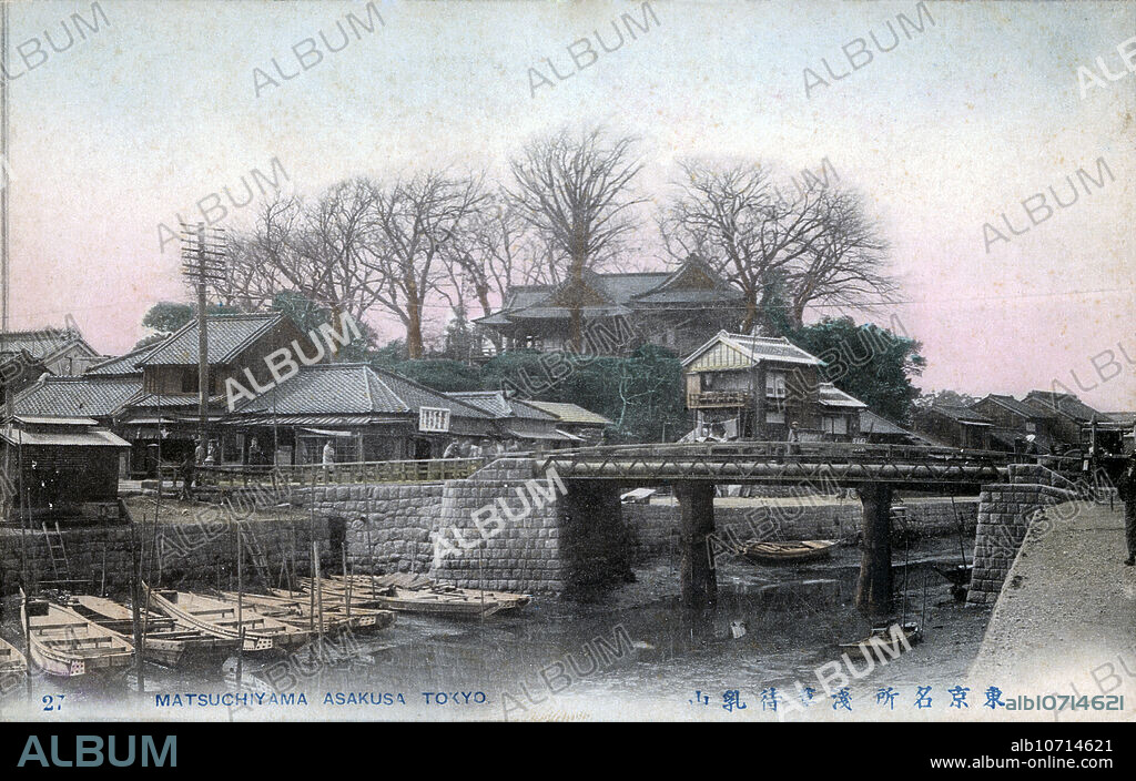 [ 1900s Japan - Local Scene in Tokyo's Asakusa ] Imadobashi Bridge spanning the Sanyabori canal in the Asakusa district of Tokyo. In the back is Matsuchiyama, a small hill on the west side of the Sumida River. On top, Honryuin Temple can be seen. Locally known as Matsuchiyama Shoden, it is a sub temple of Sensoji and dedicated to Bishamonten, one of the Seven Gods of Good Luck. 20th century vintage postcard.