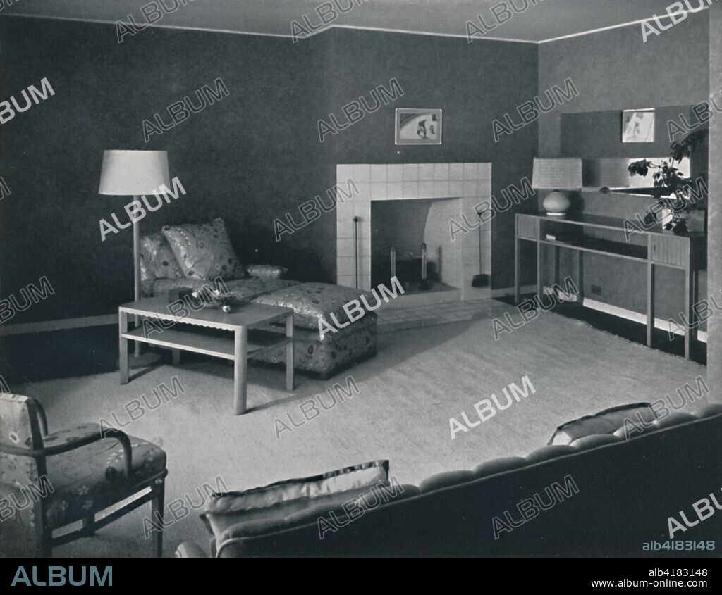 'Bedroom in the house of Mr. Anatole Litvak in Saint Monica, California', USA, 1942. Architects: Douglas Honnold and George Vernon Russell. Home of film director Anatole Litvak, with interior design by fellow director Harold W Grieve. Tiled fireplace, pickled oak furniture, cotton rug, flowered chintz upholstery, lampshade of woven reed, cellophane and raw silk. From Decorative Art 1942 - The Studio Year Book, edited by C. G. Holme. [The Studio Ltd., London, 1942].
