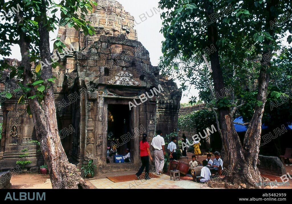 The laterite temple of Ta Prohm was built by King Jayavarman VII on top of an earlier 6th century Khmer shrine. The result is a well-preserved gem of a temple, not unduly large, but with some splendid decorative features. The main sanctuary has five chambers, in each of which is a statue or a Shiva lingam. Jayavarman VII (1125–1215) was a king (reigned c. 1181-1215) of the Khmer Empire at Angkor. Cambodia. He was the son of King Dharanindravarman II (r. 1150-1160) and Queen Sri Jayarajacudamani. He married Jayarajadevi and then, after her death, married her sister Indradevi. The two women are commonly thought to have been a great inspiration to him, particularly in his unusual devotion to Buddhism, as only one prior Khmer king had been a Buddhist.