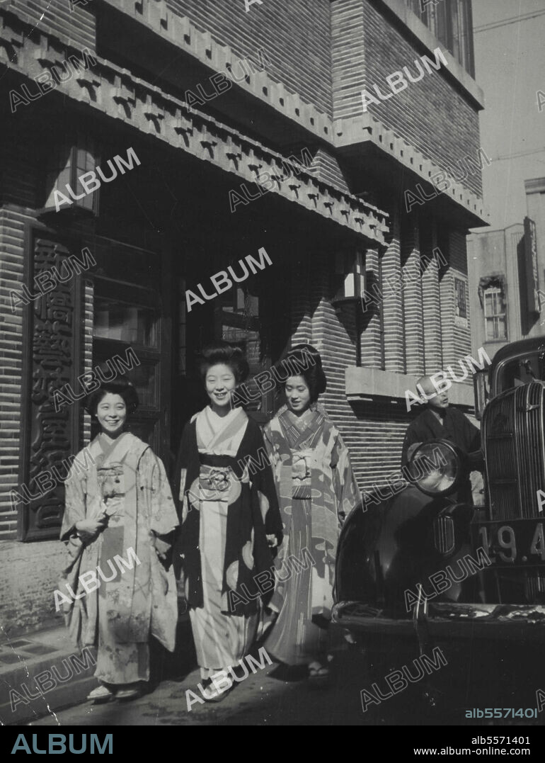 Life Of The Geisha (11) -- In front of the headquarters of the Shinbashi geisha guild, Tokyo. The guild maintains a staff of clerks and attendants, serving as business intermediary between Japanese-style restaurants and geisha houses. Geisha are hired by the hour, separately for each group of guests in private dining halls. The guild protects the interests of both the geisha and the restaurant guests, obviates racketeering. May 02, 1942. (Photo by Japan Photo Library).
