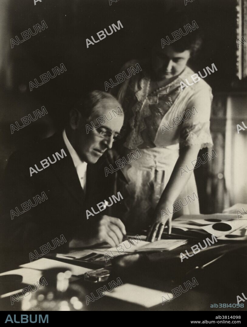 Entitled: President Wilson, seated at desk with his wife, Edith, June 1920. Thomas Woodrow Wilson (December 28, 1856 - February 3, 1924) was the 28th President of the USA (1913-21). Wilson was elected President as a Democrat in 1912. During WWI, he raised billions of dollars through Liberty Bonds, set up the War Industries Board, took over control of the railroads, and suppressed anti-war movements. In the late stages of the war, Wilson took personal control of negotiations with Germany, including the armistice. In 1919, he went to Paris to create the League of Nations and shape the Treaty of Versailles. For his peace-making efforts He was awarded the 1919 Nobel Peace Prize. Edith Bolling Galt Wilson (October 15, 1872 - December 28, 1961) was the second wife of Woodrow Wilson and First Lady from 1915-21. President Wilson suffered a severe stroke in October 1919. Edith Wilson began to screen all matters of state and decided which were important enough to bring to the bedridden president. In doing so, she functionally ran the Executive branch of the government for the remainder of the president's second term, until March 1921. She retired with the former president to their home, nursing him until his death three years later. She died of congestive heart failure at age 89 in 1961.