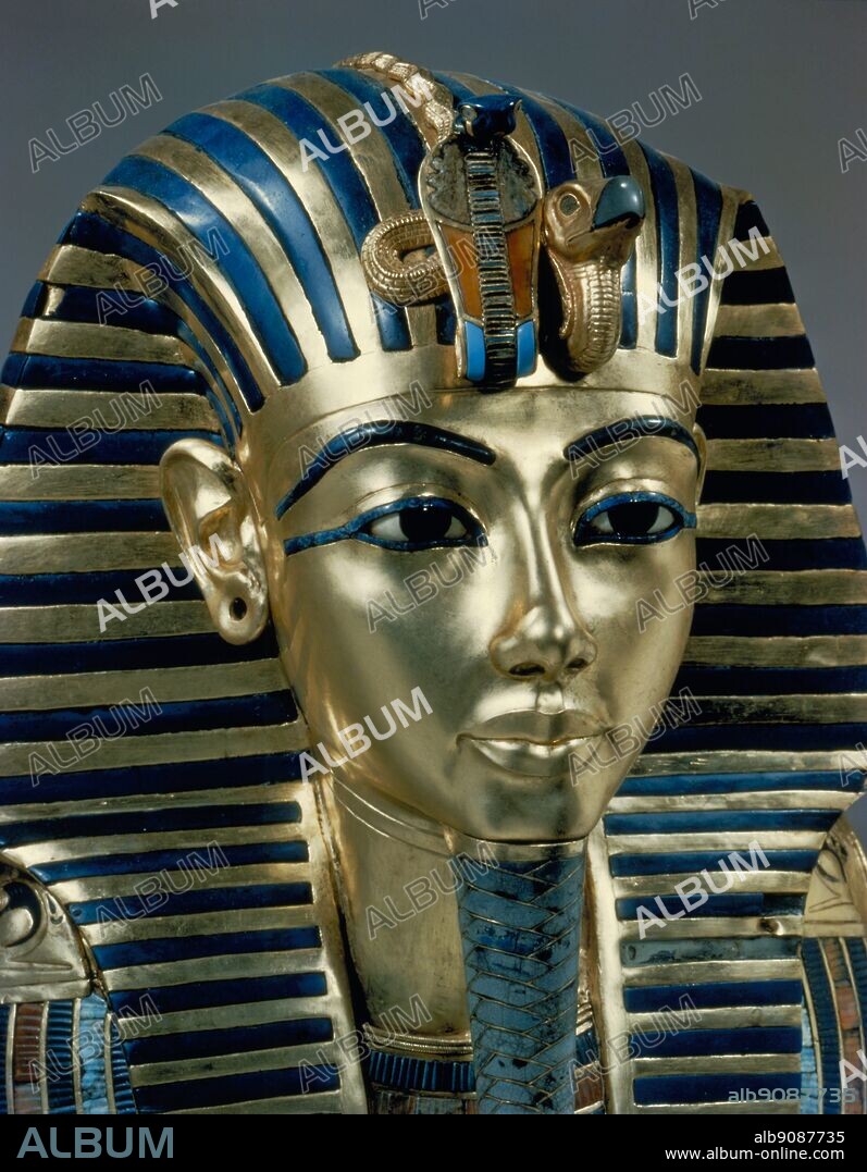 Tutankhamen - Tut Pl. 26 (XXVI) Gold Mask (found by Howard Carter) . Tutankhamen's funeral mask in solid gold, inlaid with semi-precious stones and glass paste. Tukankhamen, by Christiane Desroches Noblecourt, The mask of Tutankhamen's mummy is now a popular icon for Ancient Egypt - the close-up of Tutankhamun's facial features as represented by 18th Dynasty artisans in the young king's death mask. The Egyptologist Howard Carter (employed by Lord Carnarvon) discovered Tutankhamun's tomb (since designated KV62) in The Valley of The Kings on November 4, 1922 near the entrance to the tomb of Ramses VI. Carter contacted his patron, and on 26 November 1922 both men became the first people to enter Tutankhamun's tomb in over 3000 years. After many weeks of careful excavation, on 16 February 1923 Carter opened the inner chamber and first saw the sarcophagus of Tutankhamun. The sarcophagus contained three gold coffins nested within each other. Inside the final one was the mummy of the boy-king, Pharaoh Tutankhamen.. © TopFoto.