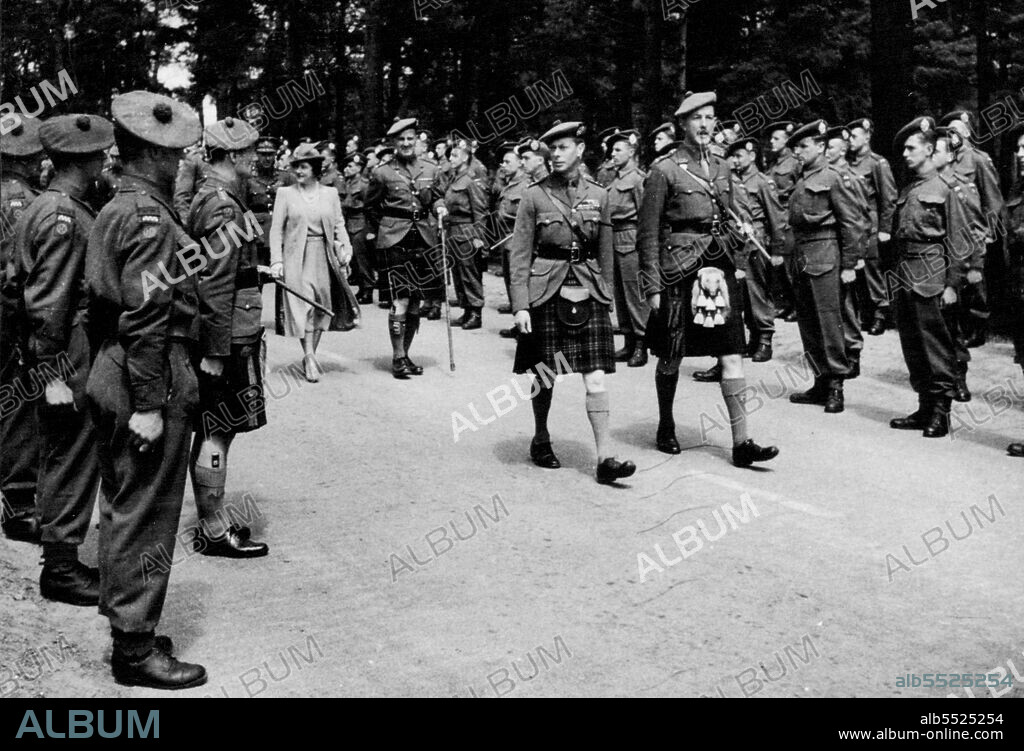 The King and Queen Inspecting Highland Units - Walking with the King is Lt. Colonel Lorne MacLaine Campbell D.S.C. who had been awarded the V.C. for galantry in Tunisia. August 30, 1943. (Photo by British Official Photograph).
