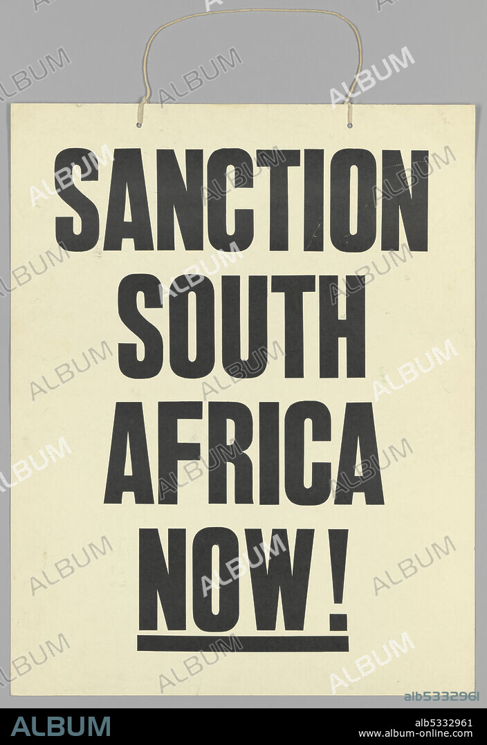 Protest sign calling for economic sanctions agains the apartheid regime of South Africa. The placard is somewhat larger than an average human torso, white, and rectangular. It is relatively sturdy paper, similar to thick cardstock, with two punched holes, roughly seven inches apart, centered at the top. String threads through both holes and is meant to support the weight of the placard when hung around the neck. There are 4 lines of large black text centered on the placard's front which reads: [SANCTION/SOUTH/AFRICA/NOW!]. "NOW!" also has a bolded underline.