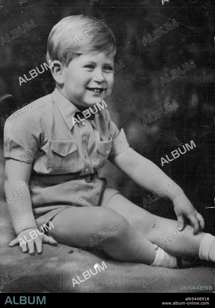 Prince Charles, dressed for a State occasion, wears a romper suit and an American-style bowtie. He is fair-haired, blue-eyed. Prince Charles... in baby bow tie, double breaster. Bow ties are smart for boys, as Prince Charles shows here. He wears this one with check romper suit. March 24, 1952. (Photo by The Associated Press Ltd.).
