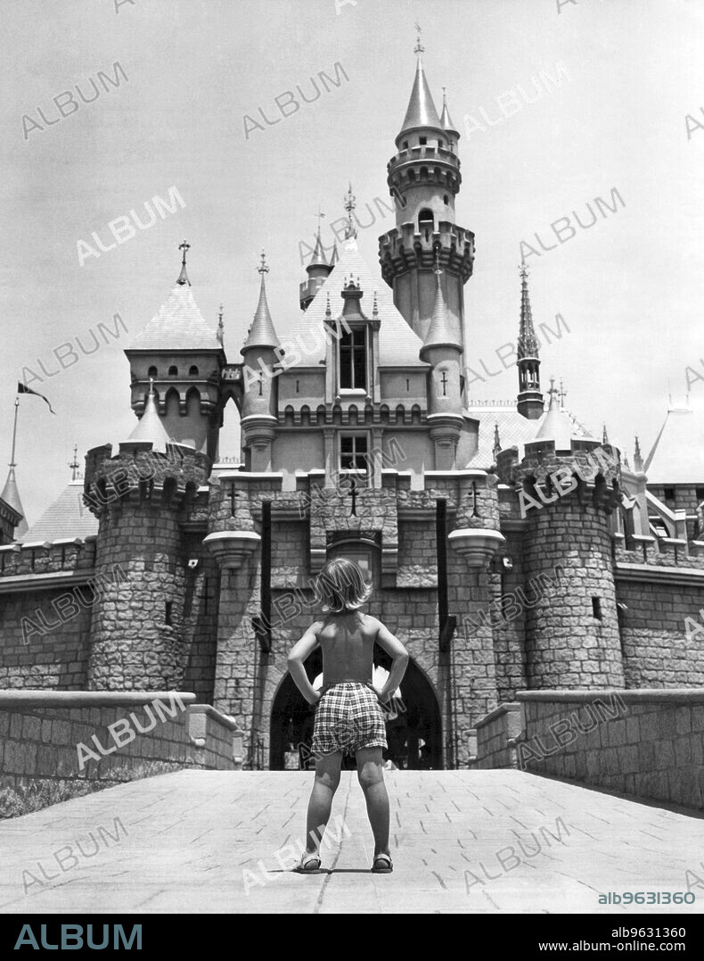 Anaheim, California, July 13, 1955 Rear view of five year Andree Nerpel as he gazes up at Disneyland's Sleeping Beauty Castle just days before the park's grand opening. The turreted castle is complete with moat and drawbridge.