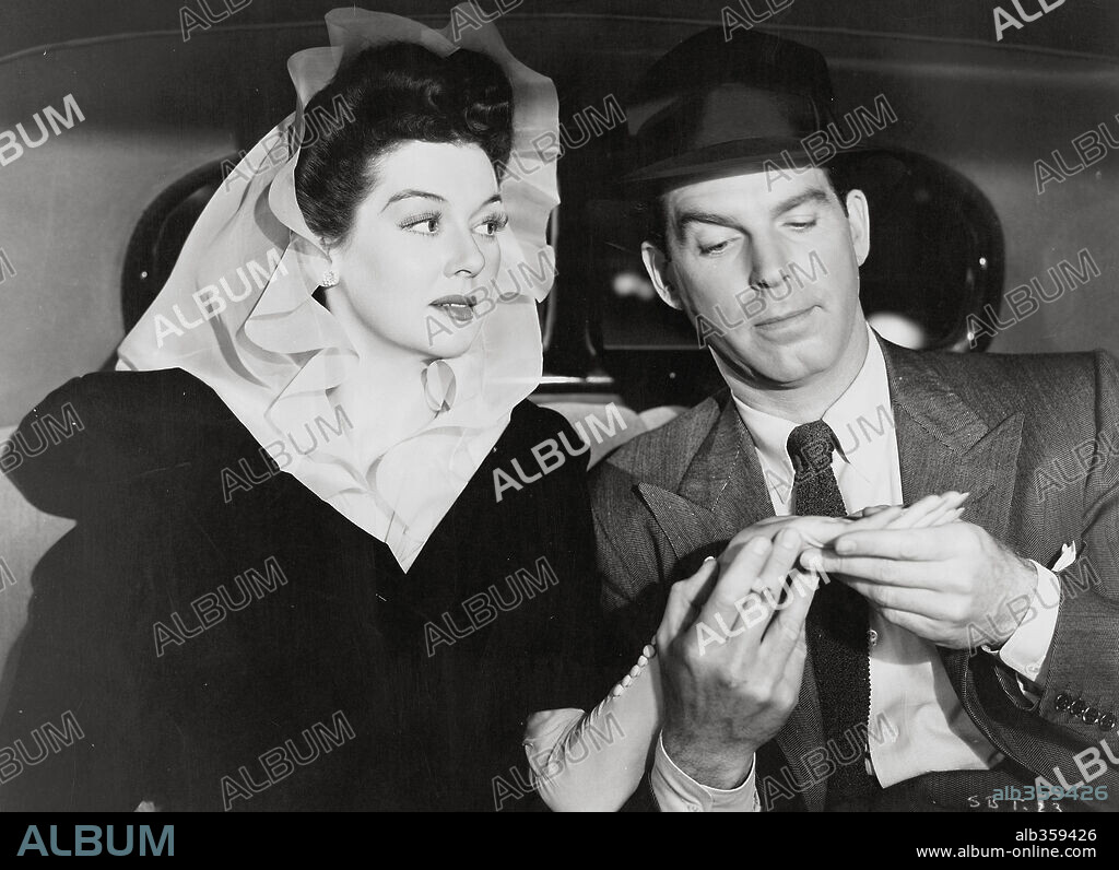 FRED MACMURRAY and ROSALIND RUSSELL in FLIGHT FOR FREEDOM, 1943, directed by LOTHAR MENDES. Copyright RKO RADIO.