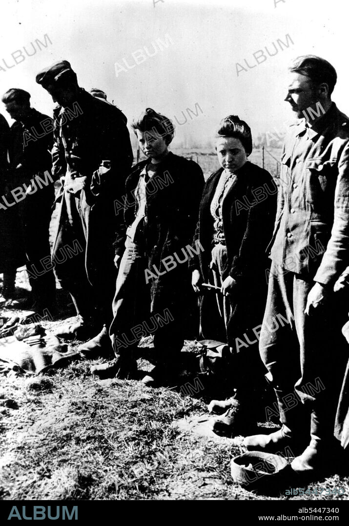 Women Captured with German Troops : Two German Women are shown with some of the 11,000 enemy troops captured in the Kaiserslautern area by the Seventh U.S. Army. They were taken when the enemy's resistance completely collapsed in the Saar and Palatinate. June 04, 1945. (Photo by U.S. Office of War Information Picture).