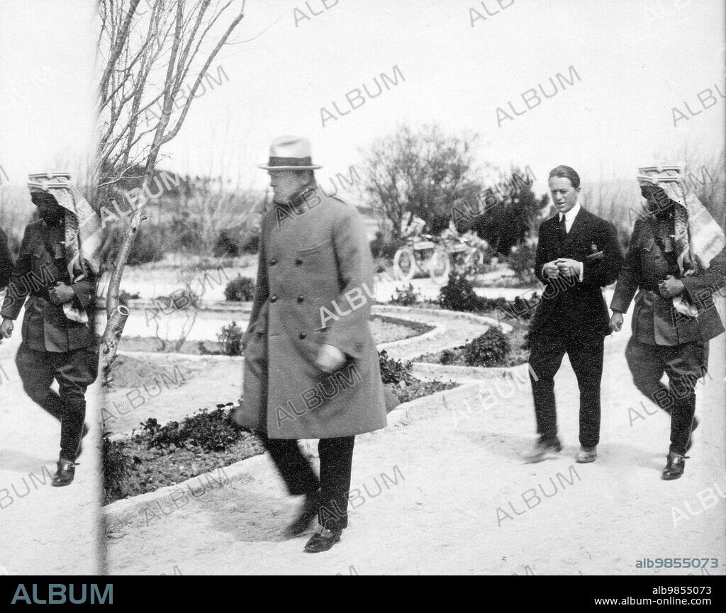 British Secretary of State for the Colonies Winston Churchill walking ahead of T.E. Lawrence and Emir Abdullah in the garden of Government House, Jerusalem, Mandatory Palestine, G. Eric and Edith Matson Photograph Collection, 1921.