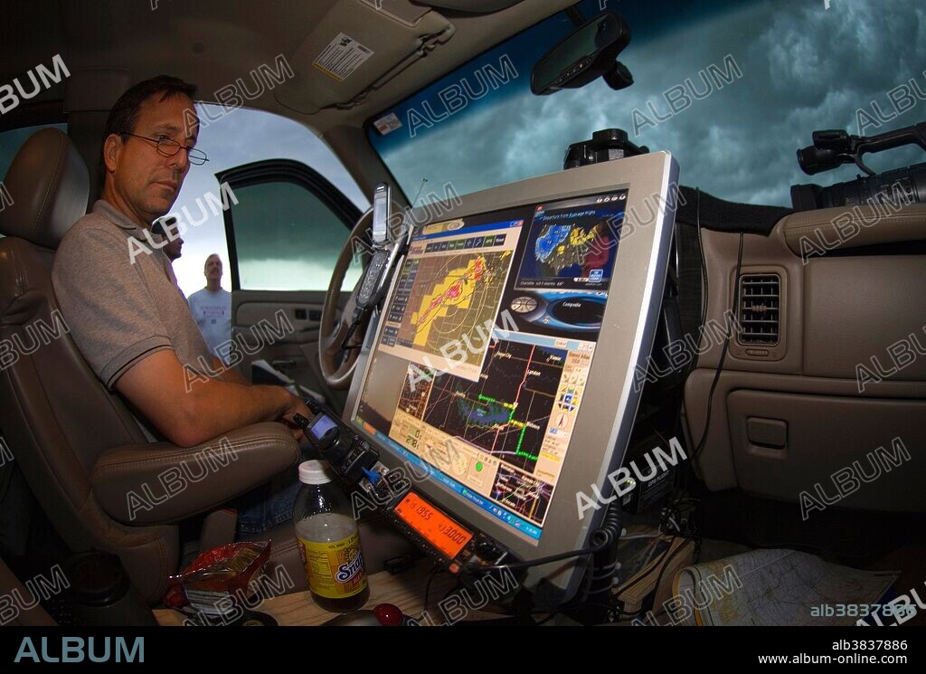 Tornado researcher Tim Samaras monitors radar from inside his storm chase vehicle.