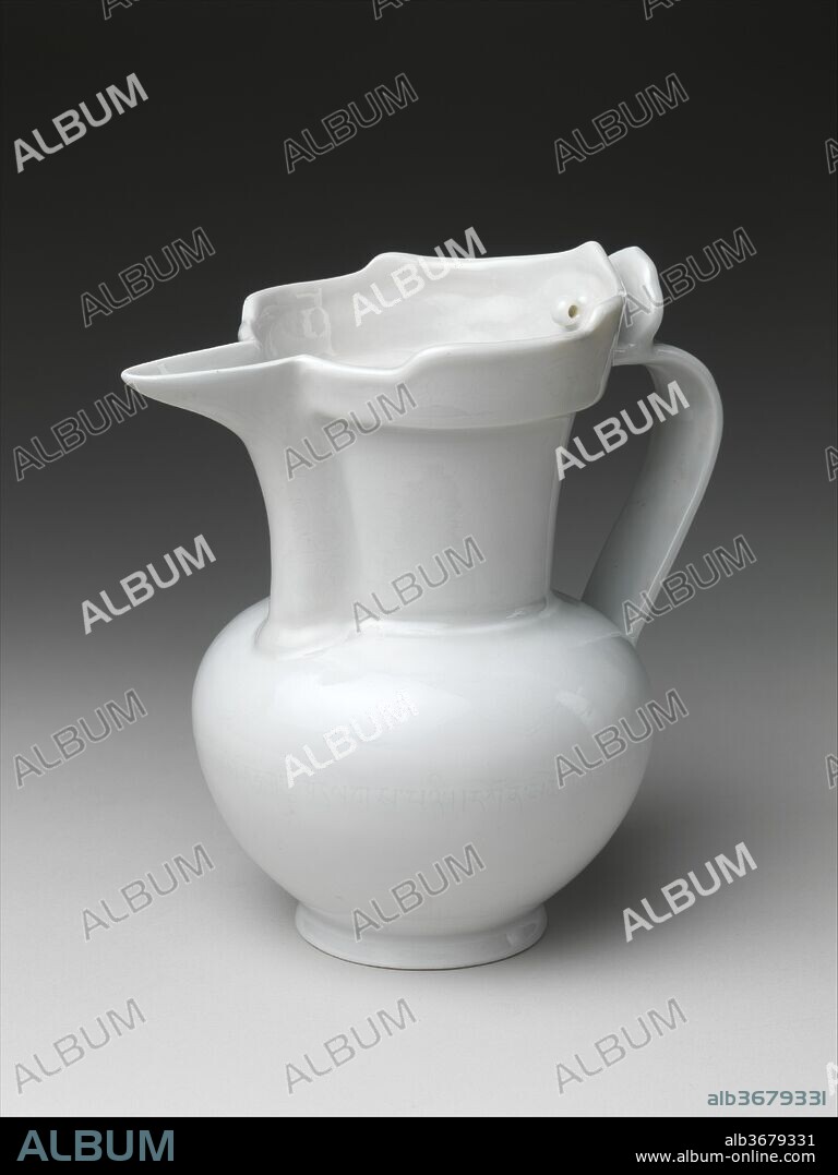 Ewer in the Shape of a Tibetan Monk's Cap. Culture: China. Dimensions: H. 8 in. (20.3 cm); W. at spout 8 in. (20.3 cm); Diam. of foot 3 in. (7.6 cm). Date: early 15th century.
Possibly originally intended for use in Buddhist rituals, ewers like this, which allude to the shape of a Tibetan monk's cap, were first produced in the fourteenth century.