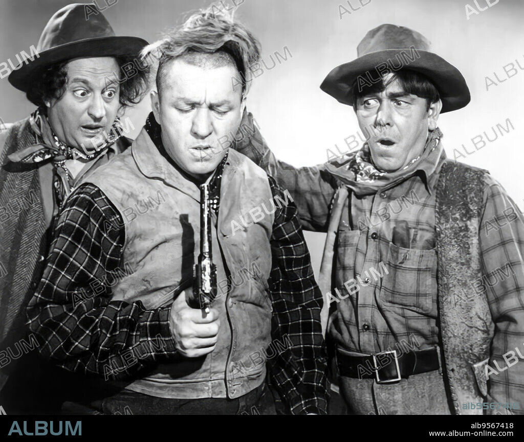 CURLY HOWARD, LARRY FINE, MOE HOWARD and THE THREE STOOGES in THE THREE TROUBLEDOERS, 1946, directed by EDWARD BERNDS. Copyright COLUMBIA PICTURES.