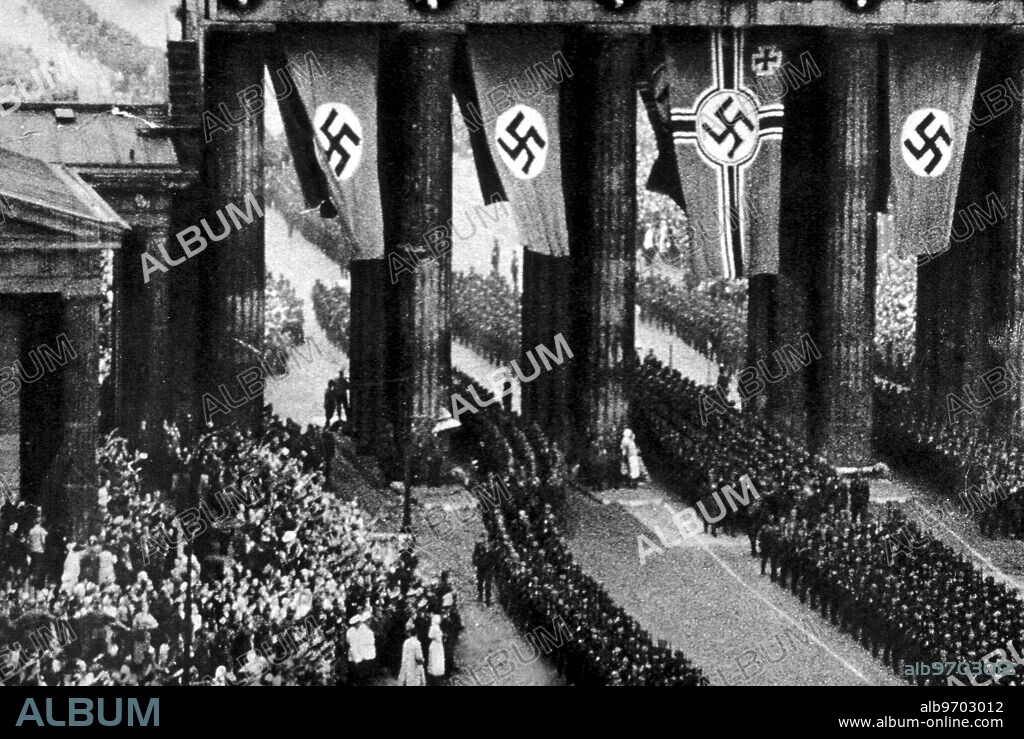 Berlin, Brandenberg Gate ( architect Karl Gotthard Langhans ) - 10th August 1940 - The most celebrated image of Berlin is the Brandenburg Gate which was isolated during partition, as it was sited in no-man's land between the east and west. The gate has a troubled history, being mutilated and damaged by regime change and wars. When originally built the gate ended Unter Linder, the leafy avenue from the Royal Palace and the Tiergarten. It was modelled on the Propylaeum on the Acropolis in Athens and the entablature motifs inspired by the Parthenon. The bronze statue with Eirene, goddess of Victory was not completed until 1793 and was designed by Gottfried Schadow. The statuary was moved to Paris by Napoleon after he captured the city in 1806. It was later returned and Schinkel added the staff with the Prussian eagle. By 1945, the gate was in poor repair and the bronze figures destroyed. The East German regime wanted to restore the gate but replace the bronze statuary with a sculpture of a socialist family facing the sun. Fortunetly sanity prevailed and the original figures were replaced. Since reunification, the gate has been restored to all its glory. - © TopFoto / AP.
