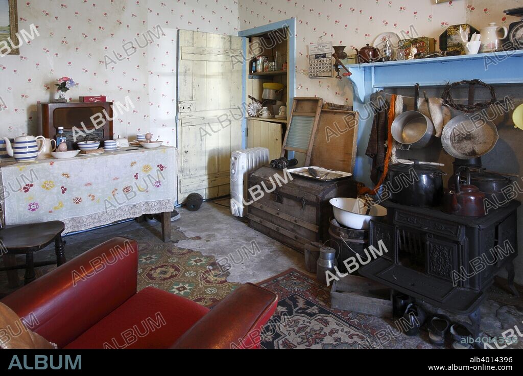 Interior of a black house, Arnol, Lewis, Outer Hebrides, Scotland, 2009. Black houses were traditional houses which used to be common in the Highlands and Islands of Scotland, as well as Ireland and areas of Gaelic settlement in Nova Scotia. Most of the examples on Lewis had fallen into ruin by the late 1970s, but several have been restored, some to serve as holiday accommodation. They were traditionally built with thick walls with a core of earth surrounded by stone, and with roofs of thatced cereal straw over turf.