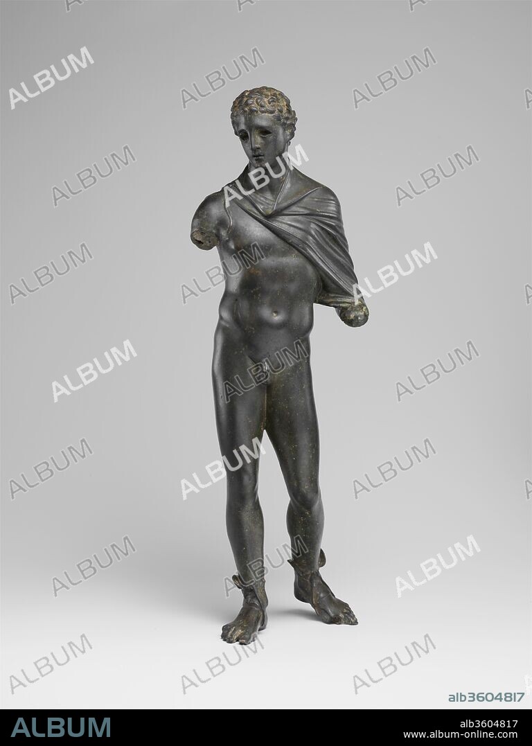 Bronze statuette of Hermes. Culture: Greek or Roman. Dimensions: H. 11 7/16 in. (29.1 cm). Date: 1st century B.C.-1st century A.D..
Hermes--messenger of the gods, the cattle rustler, the inventor of the lyre, the guider of souls across the River Styx, the manly god of boundaries--stands gracefully here rather than moving purposefully. He likely originally held his kerykeion (herald's staff) in his left hand. A pair of wings are strapped to his feet, and the small rectangular cuttings at the top of his head once held wings that sprang from his laurel-crown. The eyes, once inlaid with silver, glass paste, or stone, would have added vitality to the figure.  
The lack of interest in the specific delineation of the anatomy and the listless elegance of the pose attest to the decorative quality of this highly refined bronze. It is a sophisticated work, executed in a mannered, classicizing style that sets the god apart from the mundane world of the statuette's human owner and invites contemplation of the divine.