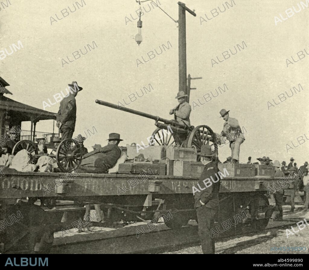 'Sergeant Borrowe and the Dynamite Gun', Spanish-American War, June 1898, (1899). Sergeant Hallett Borrowe (1864-1921) with heavy ammunition mounted on a railway wagon, Port Tampa, Florida, USA. Also shown is Joseph Cabell Breckinridge (1842-1920), Inspector-General of the US Army. From "The Little I saw of Cuba" by Burr McIntosh, with photographs by the author. (In 1898, American actor and journalist William Burr McIntosh went to Cuba to cover the Spanish-American War for "Leslie's Weekly" as a reporter and photographer). [F. Tennyson Neely, London & New York, 1899].