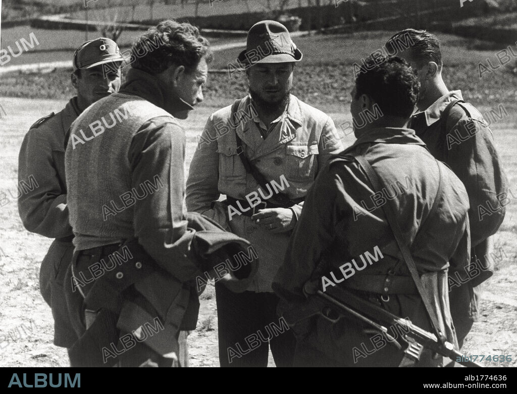 Group of partisan chiefs. A group of partisan chiefs near Alba, during a meeting; in the center, the Commander 'Mauri', nom de guerre of Major Enrico Martini. Italy, April 1945.
