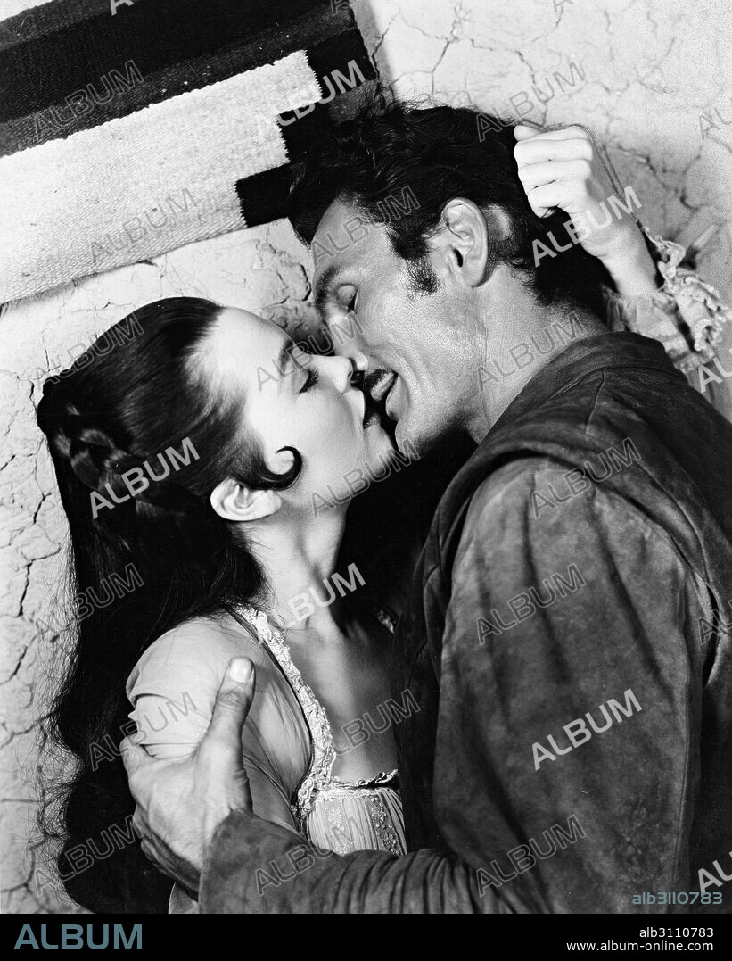 BARBARA RUSH and JACK PALANCE in KISS OF FIRE, 1955, directed by JOSEPH M. NEWMAN. Copyright UNIVERSAL INTERNATIONAL PICTURES.