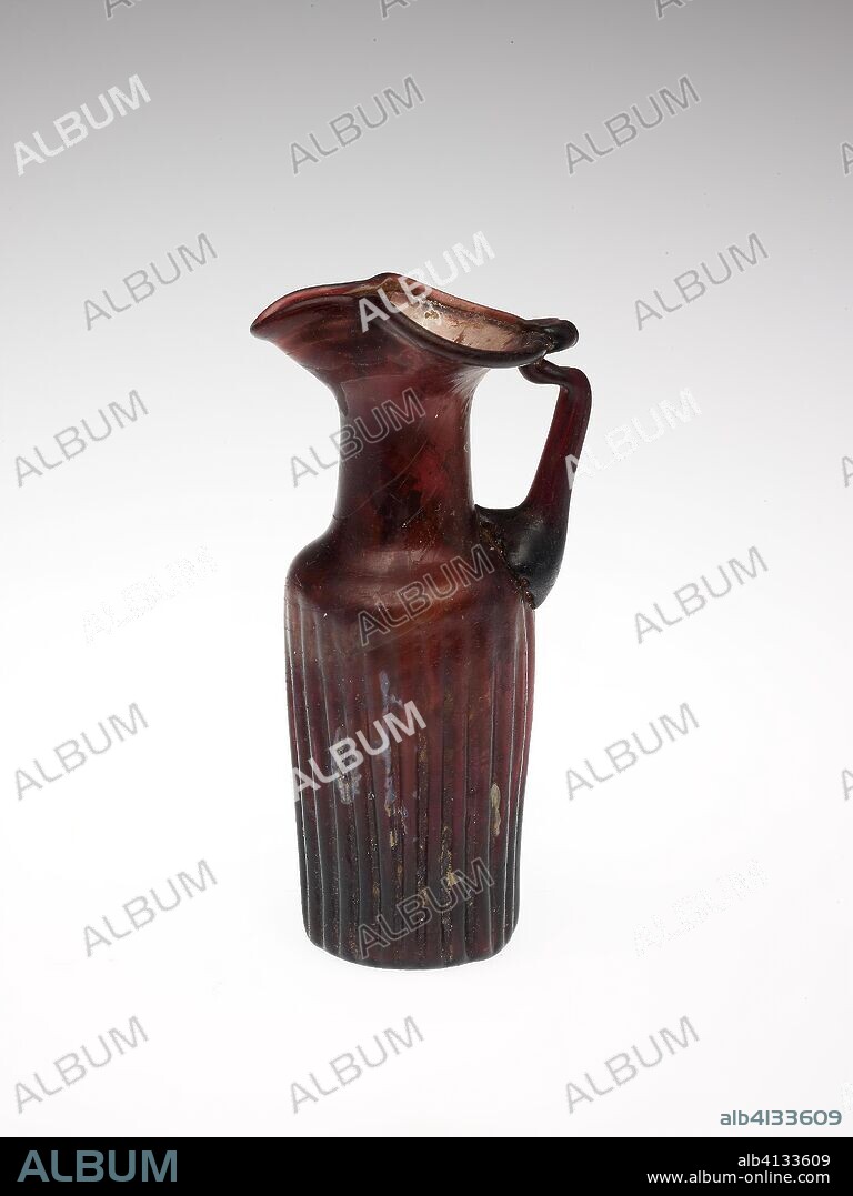 Pitcher. Byzantine; Eastern Mediterranean. Date: 401 AD-600 AD. Dimensions: 13.7 × 6.6 × 4.9 cm (5 3/8 × 2 5/8 × 1 7/8 in.). Glass, mold-blown technique. Origin: Syria.