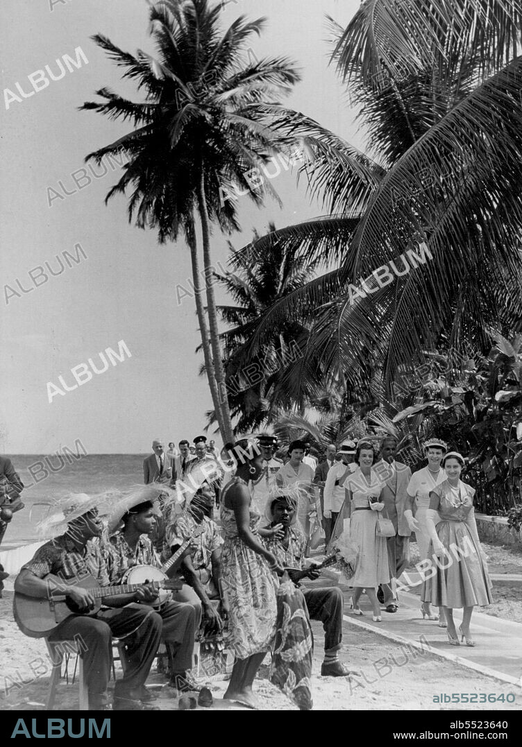 This Is It -- The picture that really captures the atmosphere of Princess Margaret's tour of the Caribbean "Carypso Islands". As the Princess walks in Jamaica, the sun shines bright and warm, palm trees away in a gentle breeze, a band plays a serenade. It is a moment that the Princess and the people will never forget. February 28, 1955. (Photo by Daily Mirror).