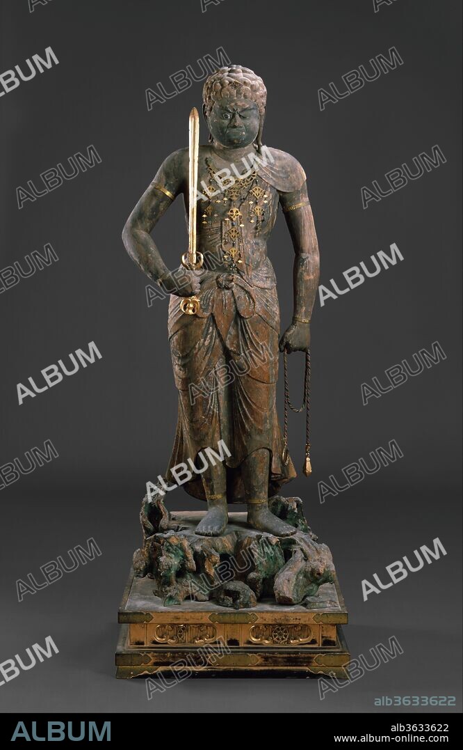 Fudo Myoo (Achala-vidyaraja). Culture: Japan. Dimensions: H. 63 3/4 in. (162 cm). Date: 12th century.
Fudo Myoo is the most widely represented of the Buddhist deities known as Myoo, or Kings of Brightness. A fierce protector of the Buddhist Law, he is a direct emanation of the Buddha Dainichi Nyorai, the principal Buddha of Esoteric Buddhism. The first sculptures of Fudo made in Japan were seated, but standing sculptures like this one were carved beginning in the eleventh century. Fudo uses his sword to cut through ignorance and his lasso to reign in those who would block the path to enlightenment. The heavy weight of the shoulders and back is planted firmly on the stiffened legs, appropriate for a deity whose name means the "Immovable." 
This statue, originally composed of six hollowed-out pieces of wood, was formerly the central icon of the Kuhonji Gomado in Funasaka, twenty miles northwest of Kyoto.