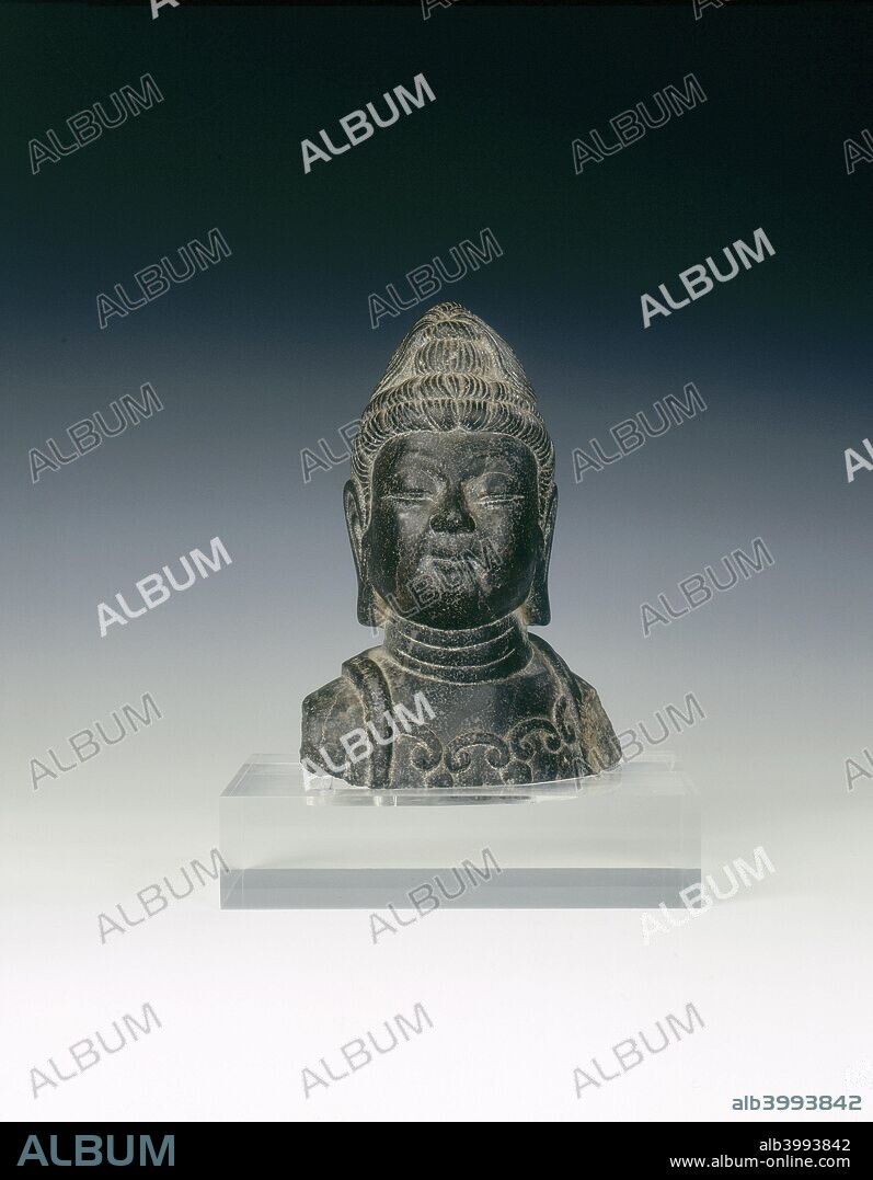 Black marble head of a Bodhisattva, China, 757-906 AD. Late Tang dynasty bust of a Bodhisattva. Its features are serene and the hair is elaborately coiffured and piled up in tresses. The neck has three prominent folds.