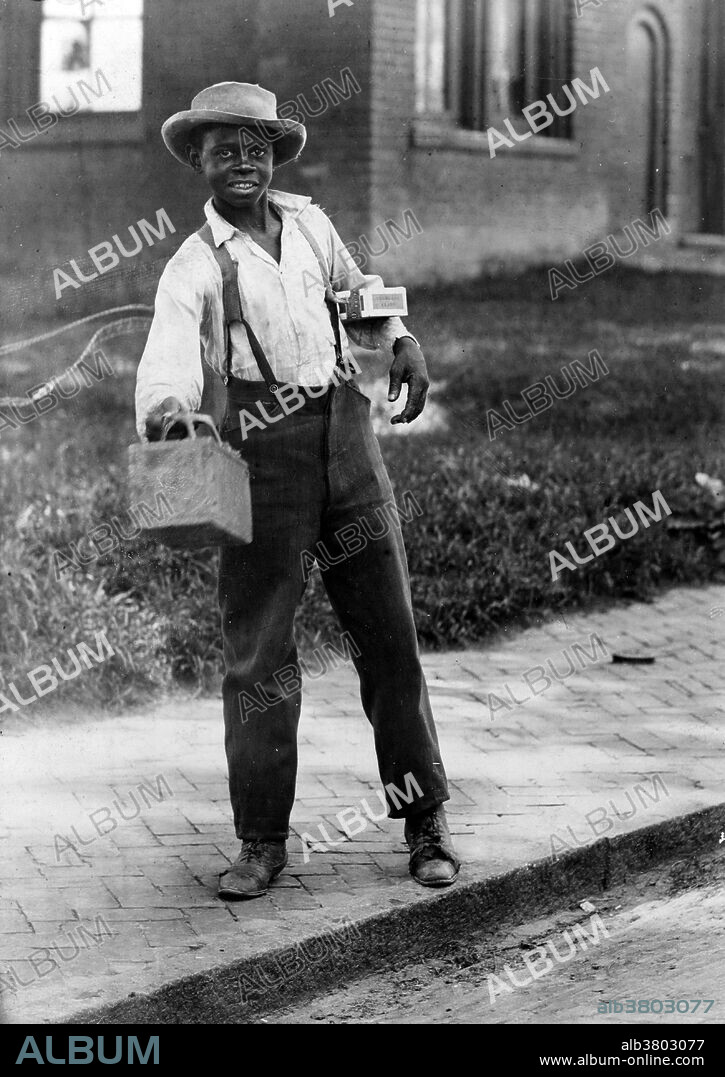 Entitled: "Shine Sah?" shows an African-American boy holding out shoe shine box. Shoeshiner or boot polisher is an occupation in which a person polishes shoes with shoe polish. They are often known as shoeshine boys because the job is traditionally that of a male child. Shoeshiners are often found working in business districts where professionals congregate. The shoeshiner is perceived as an informational hub, studiously polishing and buffing whilst dispensing helpful advice on local affairs and events. Photographed by V.G. Schreck, Savannah, Georgia, 1899.