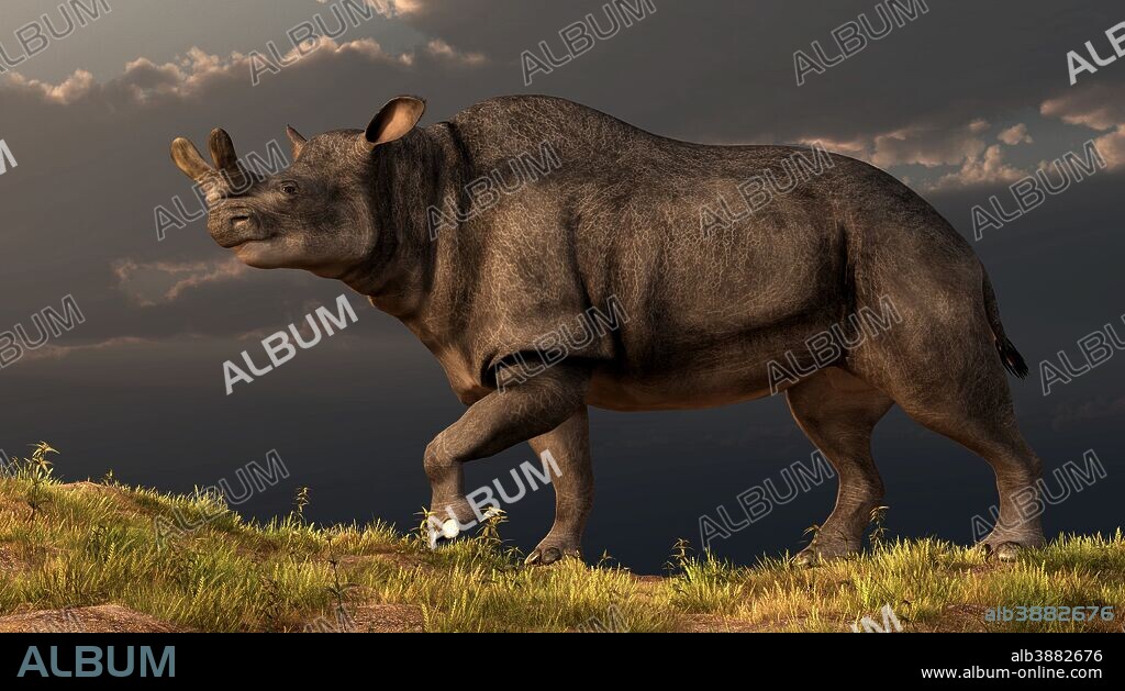 A Brontotherium walking atop a grassy hill.