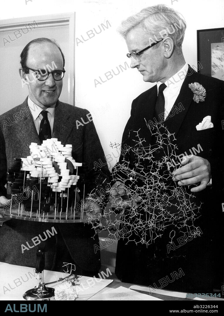 Orig. bildtext... BRITISH SCIENTISTS SHARE NOBEL CHEMISTRY PRIZE. A breakthrough in molecular chemistry earned two British scientists a share in this year's Nobel Prize for Chemistry. They are pictured in their laboratory at Cambridge University, England, examining two of the models which aided their research. On the left is Dr. Max Ferdinand Perutz, Director of the National Medical Research Council's Molecular Unit, and on the right, Dr. John Cowdrey Kendrew, deputy Director. Dr. Perutz and Dr. Kendrew led a team of scientists in probing the molecular structure of two globular proteins, myoglobin and haemoglobin - the latter being the pigment of the red blood corpuscles. In jointly winning the 1962 award, these two British scientists bring the number of Nobel Prize winners in their Cambridge laboratory to four. King Gustaf Adolf of Sweden will award Dr. Perutz and Dr. Kendrew a gold medal and diploma each and a share of the £17.740 cash prize in Stockholm on December 10. Nobelpriset i kemi 1962 persons: John Kendrew ;Max Perutz sites: STORBRITANNIEN PhotoDate:1962-11-??.