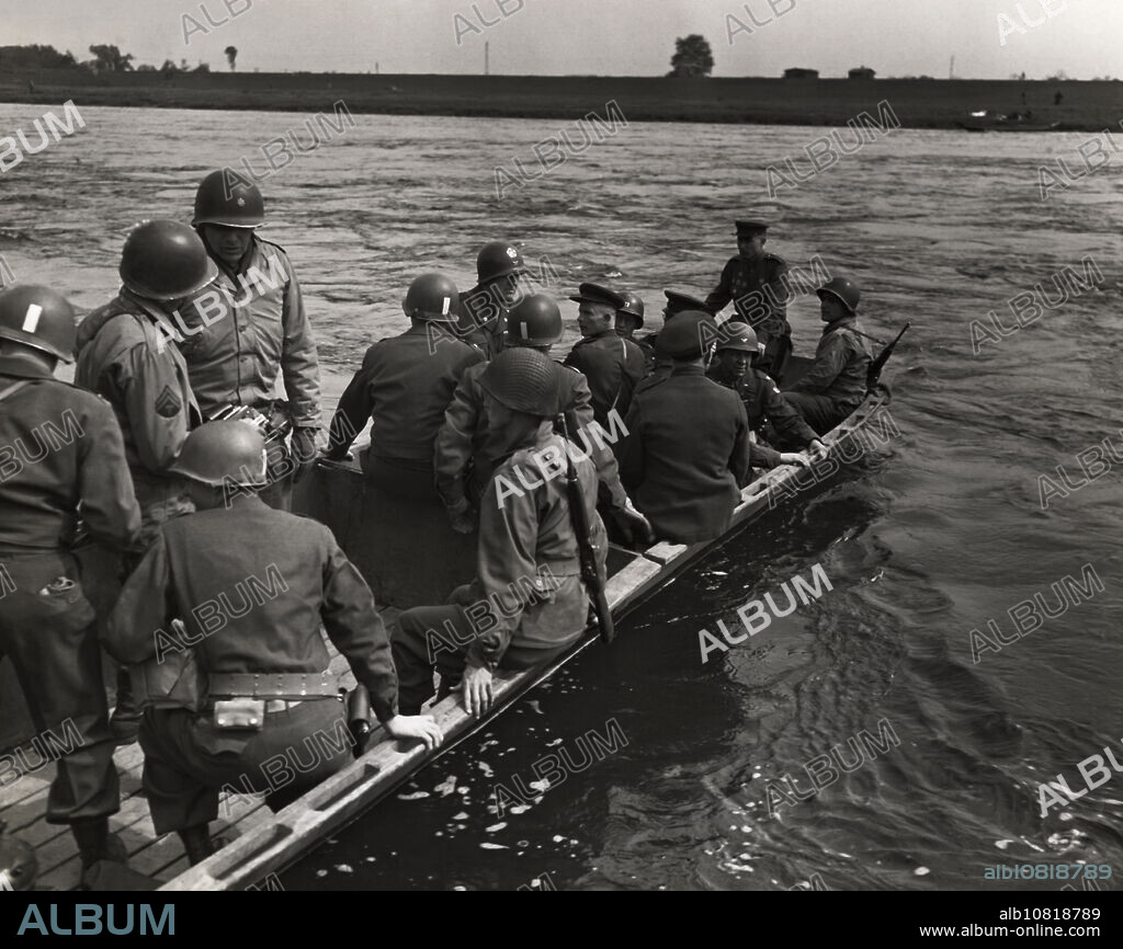 Torgau, Germany April 27, 1945 Maj. Gen. Clarence R. Huebner, the Commanding General of the V Corps, and Russian Maj. Gen. Rusakof, 58th Infantry Division, Russian Army, with their staffs, cross the Elbe River for a conference with the Commanding General of the Russian 34th Corps.