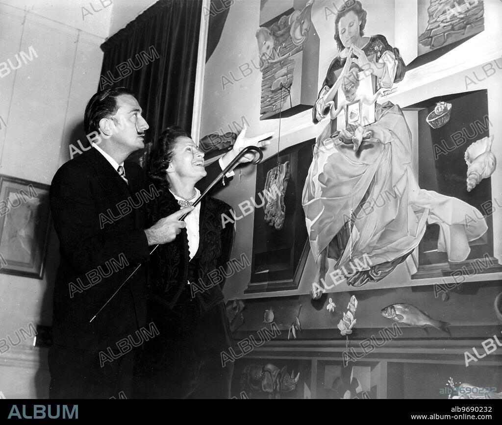 SALVADOR DALÍ. Salvador Dali in London at an exhibition of his work in the Lefevre Galleries. The painting is called Madonna of Port Lligat for which his wife Gala is the model.. 2nd December 1951.