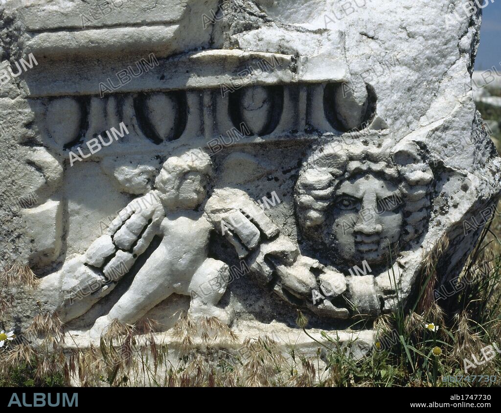 Hierapolis. Ancient city in classical Phrygia, Anatolia. Depiction of a theatrical mask and cupid holding a garland. Fragment of the theater frieze, built in the 2nd century. Turkey.