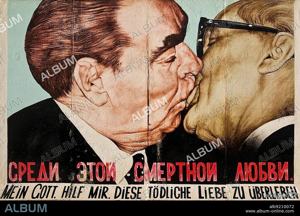 Brotherly Kiss, Brezhnev kisses Honecker, mural by Dmitri Vrubel on a remnant of the Berlin Wall, East Side Gallery, Berlin, Germany, Europe.