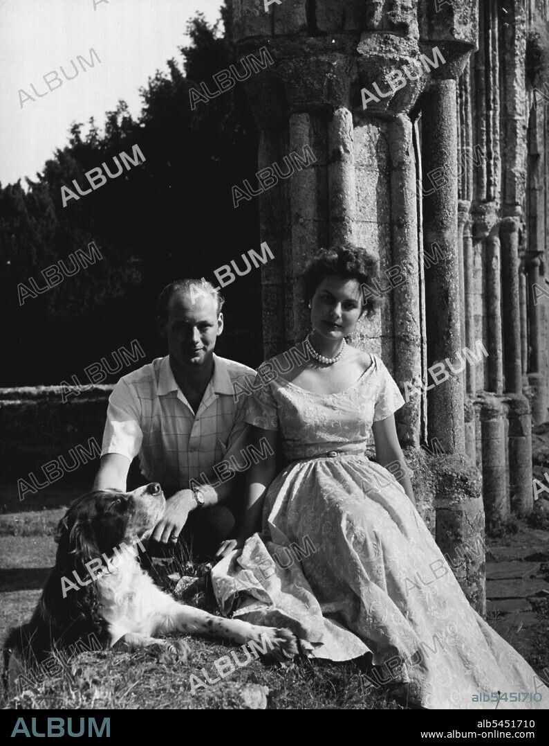 Lord Montagu Of Beaulieu With His Fiancee Miss Ann Gage -- Edward John Barrington Douglas-Scott-Montagu, 3rd Baron Montagu of Beaulieu, photographed with his fiancee, Miss Ann Gage, in the grounds of Palace House, Beaulieu, Lord Montagu's mansion in Hampshire. Miss Gage is the daughter of Major and Mrs. Edward Gage of Chyknell, Bridgnorth, Shropshire. August 21, 1953. (Photo by Anthony Armstrong-Jones, Camera Press).
