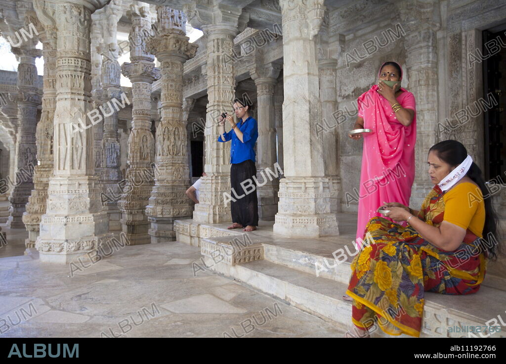 Jain pilgrims with traditional masks at The Ranakpur Jain Temple at Desuri Tehsil in Pali District, Rajasthan, India.
