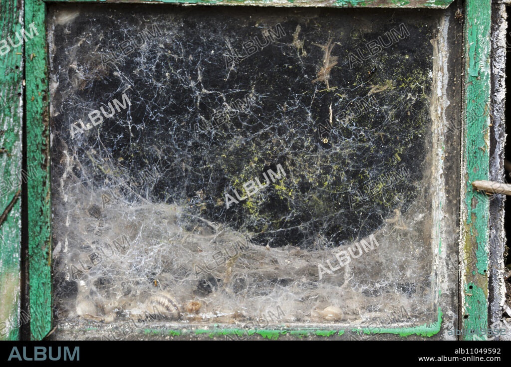 old damaged window on a farm in Liencres, Cantabria, Spain.
