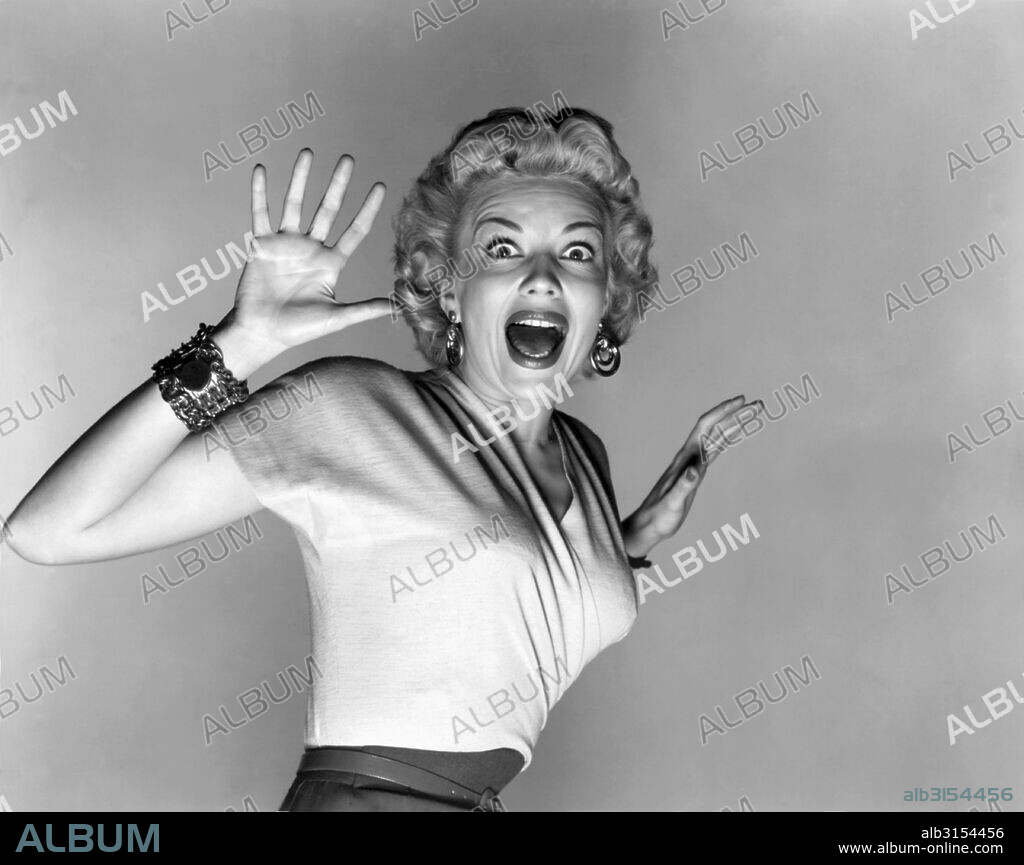 Hollywood, California:  1953.  Actress Kathleen Hughes reacts to the aliens in a promo still for the sc-fi thriller movie, 'It Came From Outer Space'. It was Universal Studio's first movie to be filmed in 3-D.