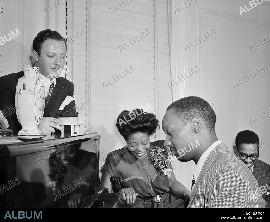WILLIAM PAUL GOTTLIEB. Portrait of Milt Orent, Mary Lou Williams, Hank Jones, and Dizzy Gillespie, Mary Lou Williams' apartment, New York, N.Y., ca. Aug. 1947.