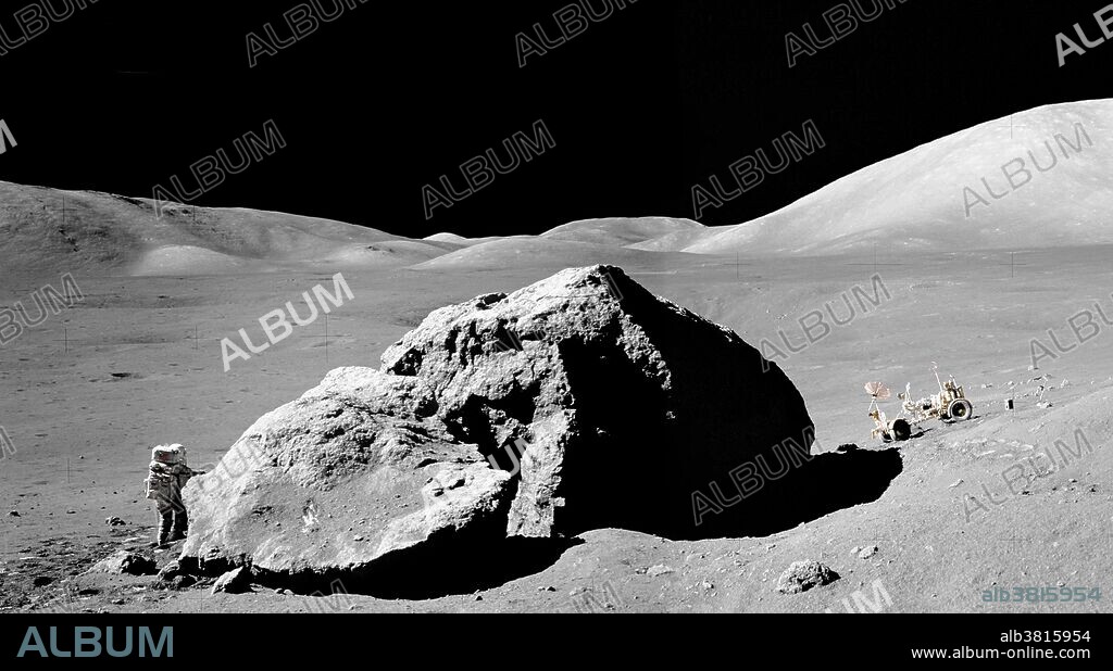 Astronaut Harrison H. Schmitt and the Lunar Roving Vehicle flank 'Tracy's Rock', aka Split Rock, or the Station 6 Boulder, during the third Apollo 17 extravehicular activity at the Taurus-Littrow landing site on December 13, 1972. The image was captured by astronaut Eugene A. Cernan, mission commander. While astronauts Cernan and Schmitt descended in the Lunar Module "Challenger" to explore the lunar surface, astronaut Ronald E. Evans, command module pilot, remained with the Command and Service Modules in lunar orbit. This image is a composite of two NASA images.