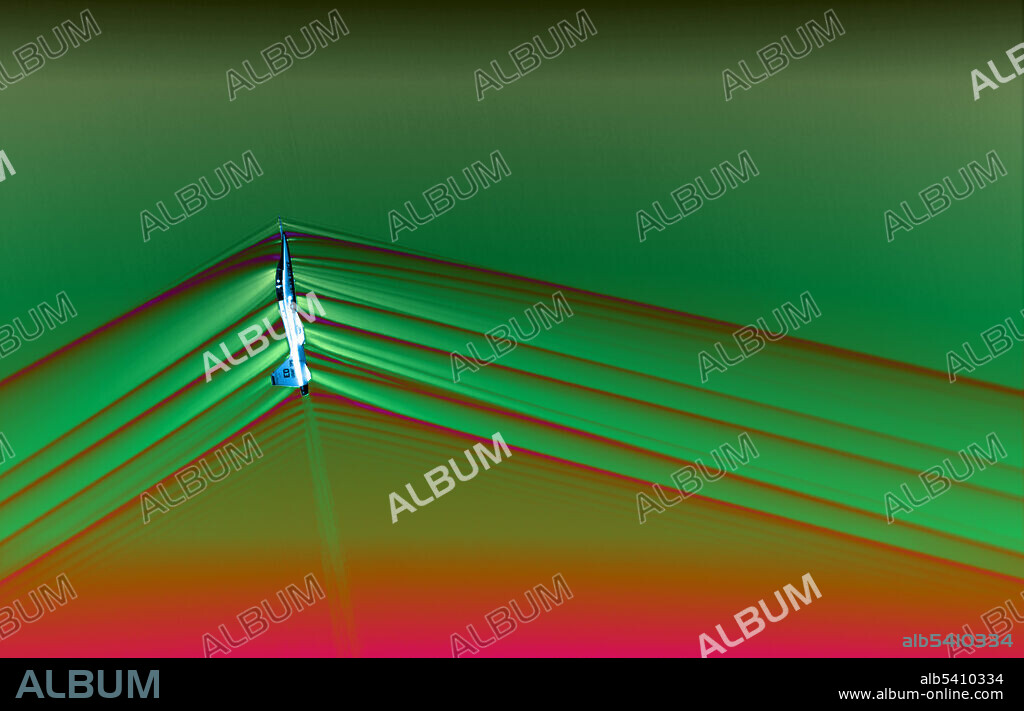 Colorized image of a Northrup T-38 Talon supersonic jet breaking the sound barrier. This image was captured during Air-to-Air Background Oriented Schlieren flights, or AirBOS, which took place at NASA’s Armstrong Flight Research Center in Edwards, California. The flight series tested an upgraded imaging system capable of capturing high-quality images of shockwaves, rapid pressure changes which are produced when an aircraft flies faster than the speed of sound, or supersonic. Shockwaves produced by aircraft merge together as they travel through the atmosphere and are responsible for what is heard on the ground as a sonic boom.