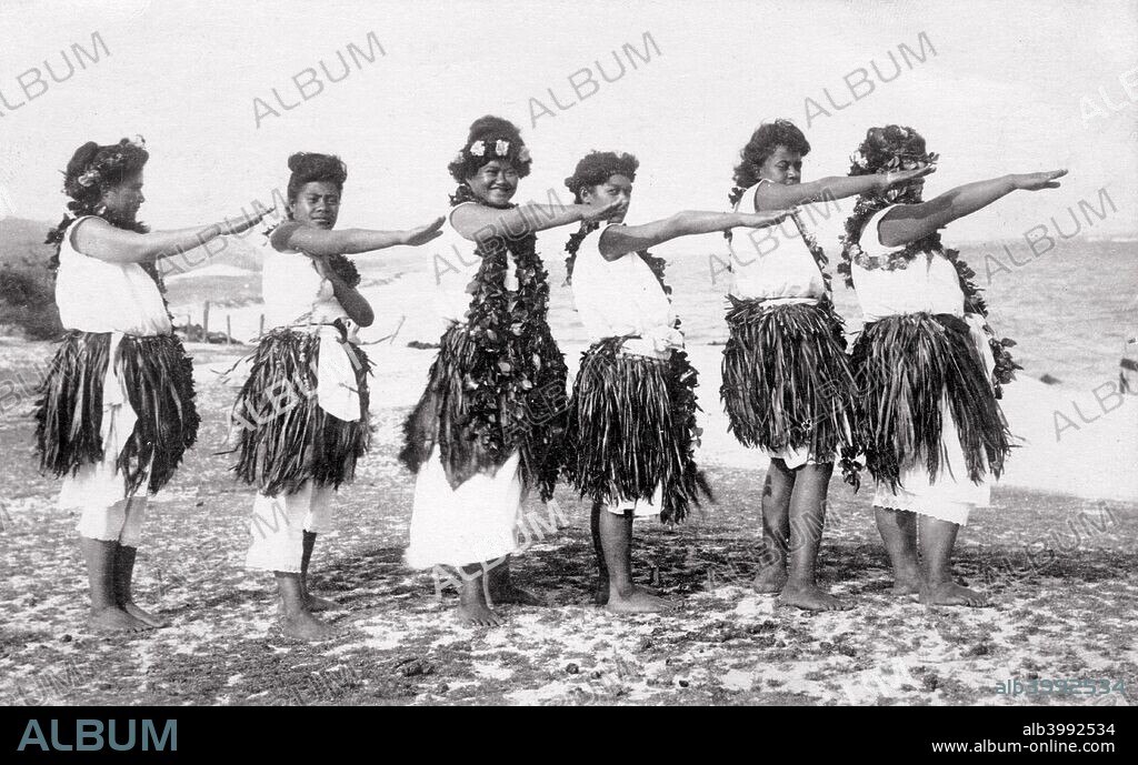 Hula girls, Honolulu, Hawaii, USA, 1919. View shows a line of Hawaiian women wearing grass skirts on a beach doing a hula dance.