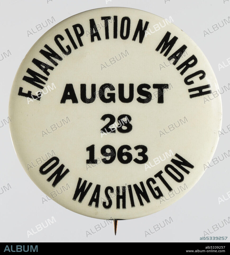 The purpose of the 1963 March on Washington for Jobs and Freedom was to advocate for the civil and economic rights of African Americans. A white pin-back button with black text. Around the edges of the front, on the top and bottom, is text surrounding more inner text. Inside the outside circle of text is the date for the March on Washington in 1963. [EMANCIPATION MARCH / AUGUST / 28 / 1963 / ON WASHINGTON]. On the reverse is a rectangular sticker with text [MLK I / HAVE A / DREAM / 912].