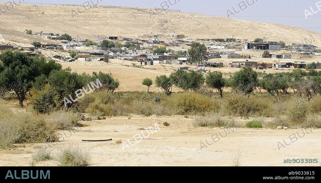 Bedouin Arab encampment with semi-permanent structures and solar energy panels; in Southern Israel. The Bedouin are a predominantly desert-dwelling; Arab ethnic group; traditionally divided into tribes or clans. Most Bedouins have abandoned their nomadic and tribal traditions for modern urban lifestyle; they retain traditional Bedouin culture; traditional music; poetry; dances.